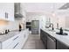 Modern kitchen featuring stainless steel appliances and island with sink, for easy food preparation at 609 Monaco Dr, Punta Gorda, FL 33950