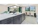 Kitchen island bar with granite countertop, stainless steel dishwasher, with view of living room at 609 Monaco Dr, Punta Gorda, FL 33950