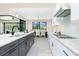 Modern kitchen with island bar, stainless steel dishwasher, and view of dining area at 609 Monaco Dr, Punta Gorda, FL 33950