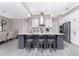 An open-concept kitchen boasts a spacious island with seating, stainless steel appliances, and contemporary lighting fixtures at 609 Monaco Dr, Punta Gorda, FL 33950
