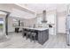 Bright kitchen featuring a center island with seating, modern appliances, and seamless access to an outdoor area at 609 Monaco Dr, Punta Gorda, FL 33950