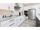 Bright, modern kitchen featuring granite countertops, stainless appliances, and ample white cabinets for storage at 609 Monaco Dr, Punta Gorda, FL 33950