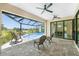 This covered lanai features ample seating and overlooks the pool and tranquil lake at 609 Monaco Dr, Punta Gorda, FL 33950