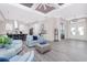 Spacious living area with stylish furnishings, modern lighting, and a glimpse into the gourmet kitchen at 609 Monaco Dr, Punta Gorda, FL 33950