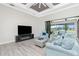 Comfortable living space with outdoor views, a modern entertainment center, and stylish, comfortable seating at 609 Monaco Dr, Punta Gorda, FL 33950