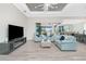 Inviting living room with a seamless transition to the outdoors, an open layout, and access to a sleek kitchen at 609 Monaco Dr, Punta Gorda, FL 33950