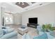 Cozy living room features a modern fireplace, comfortable seating, and a view of the front entryway at 609 Monaco Dr, Punta Gorda, FL 33950