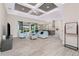 Open-concept living room boasts modern ceiling detail, light tile flooring, and seamless access to the outdoors at 609 Monaco Dr, Punta Gorda, FL 33950