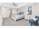 Bright main bedroom featuring a ceiling fan, wood-look tile floors and a seating area at 609 Monaco Dr, Punta Gorda, FL 33950