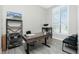 Bright office space features a wooden desk, shelving, and large window with shutter blinds at 609 Monaco Dr, Punta Gorda, FL 33950