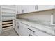 Butler's pantry with custom cabinets, drawers, open shelves and granite countertop at 609 Monaco Dr, Punta Gorda, FL 33950