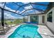 A covered pool area features a beautiful blue pool, covered lanai, and relaxing seating at 609 Monaco Dr, Punta Gorda, FL 33950