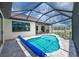 Sparkling blue swimming pool with covered lanai and comfortable outdoor seating area at 609 Monaco Dr, Punta Gorda, FL 33950
