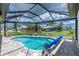 A stunning backyard pool area boasts a covered lanai, beautiful landscaping, and privacy at 609 Monaco Dr, Punta Gorda, FL 33950