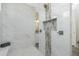Walk-in shower featuring a mosaic tile detail and marble-look wall tiles at 609 Monaco Dr, Punta Gorda, FL 33950