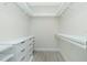 Walk-in closet with wood-look tile floors, shelving, and a built in dresser at 609 Monaco Dr, Punta Gorda, FL 33950
