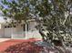 Inviting home with brick front porch and mature trees adding character and charm at 617 W Olympia Ave, Punta Gorda, FL 33950