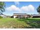 A lawn with home featuring solar panels on the roof and a screened-in patio at 6382 Cutler Ter, Port Charlotte, FL 33981