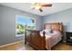 Comfortable bedroom featuring a ceiling fan and a large window with neighborhood views at 6382 Cutler Ter, Port Charlotte, FL 33981