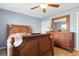 Bedroom features a ceiling fan, wooden bed frame, dresser, and a closet at 6382 Cutler Ter, Port Charlotte, FL 33981