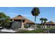 Exterior of the community clubhouse featuring stone facade and manicured landscaping at 6382 Cutler Ter, Port Charlotte, FL 33981