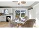 Dining room with glass table, surrounded by natural light streaming in from the sliding glass door at 6382 Cutler Ter, Port Charlotte, FL 33981
