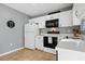 This bright kitchen has white cabinets and black appliances at 6382 Cutler Ter, Port Charlotte, FL 33981