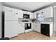 This bright kitchen has white cabinets and black appliances at 6382 Cutler Ter, Port Charlotte, FL 33981