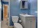Bathroom featuring blue walls, a tiled floor, and a gray vanity with modern fixtures at 6483 Fabian Rd, North Port, FL 34287