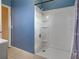Bathroom featuring a tiled floor and a shower with built-in shelves for toiletries and other bath essentials at 6483 Fabian Rd, North Port, FL 34287