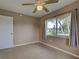 Neutral bedroom with tile flooring, natural light, and neutral curtains for added style at 6483 Fabian Rd, North Port, FL 34287