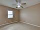 Well-lit bedroom with tiled flooring, a ceiling fan, neutral walls, and a window that allows natural light at 6483 Fabian Rd, North Port, FL 34287
