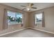 Cozy bedroom featuring neutral paint, tile flooring, and windows with curtains for added privacy at 6483 Fabian Rd, North Port, FL 34287