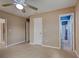 Bedroom featuring tiled floors, a ceiling fan, and multiple doors that lead to other rooms in the house at 6483 Fabian Rd, North Port, FL 34287
