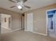 Bedroom featuring tiled floors, a ceiling fan, and multiple doors that lead to other rooms in the house at 6483 Fabian Rd, North Port, FL 34287