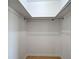 Walk in closet with skylight, tan tile floor, and a hanging rack to maximize storage capacity at 6483 Fabian Rd, North Port, FL 34287