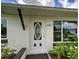 Elegant front door close-up, featuring decorative glass and clearly displayed address numbers at 6483 Fabian Rd, North Port, FL 34287