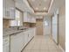 The kitchen has white cabinets, granite countertops, and a stainless steel sink with a dishwasher at 6483 Fabian Rd, North Port, FL 34287
