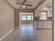 Bright kitchen featuring white cabinetry, granite countertops, and view into the dining area at 6483 Fabian Rd, North Port, FL 34287