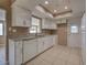 The kitchen features white cabinets, granite countertops, and stainless steel appliances at 6483 Fabian Rd, North Port, FL 34287
