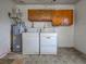 A laundry room featuring a washer, dryer, and water heater at 6483 Fabian Rd, North Port, FL 34287