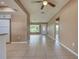 Open-concept living room with neutral paint and access to the kitchen and dining area at 6483 Fabian Rd, North Port, FL 34287