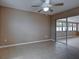 Spacious living room boasting neutral walls, tiled flooring, and sliding doors to a sun room at 6483 Fabian Rd, North Port, FL 34287