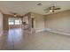 An airy living room featuring neutral paint and view into the kitchen at 6483 Fabian Rd, North Port, FL 34287