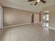 Spacious living room featuring neutral paint, ceiling fan, and large windows at 6483 Fabian Rd, North Port, FL 34287