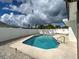 Inviting backyard pool with concrete patio and a white privacy fence at 6483 Fabian Rd, North Port, FL 34287