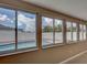 Bright sunroom with a view of the swimming pool and white fence through multiple windows at 6483 Fabian Rd, North Port, FL 34287