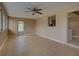 Open sunroom with beige tile flooring, lots of natural light, and views into other rooms at 6483 Fabian Rd, North Port, FL 34287