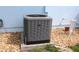 This image shows a modern Ruud air conditioning unit on gravel at 6689 Gasparilla Pines Blvd, Englewood, FL 34224