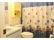 Bathroom featuring a seashell shower curtain, a sink, and a cabinet, with a touch of seaside charm at 6689 Gasparilla Pines Blvd, Englewood, FL 34224